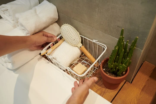 Man organizing bathroom items with a storage basket