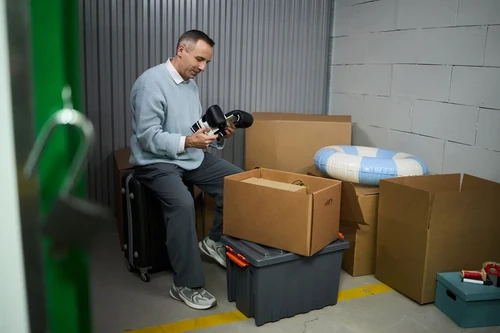 men deciding what to put into his brown storage boxes